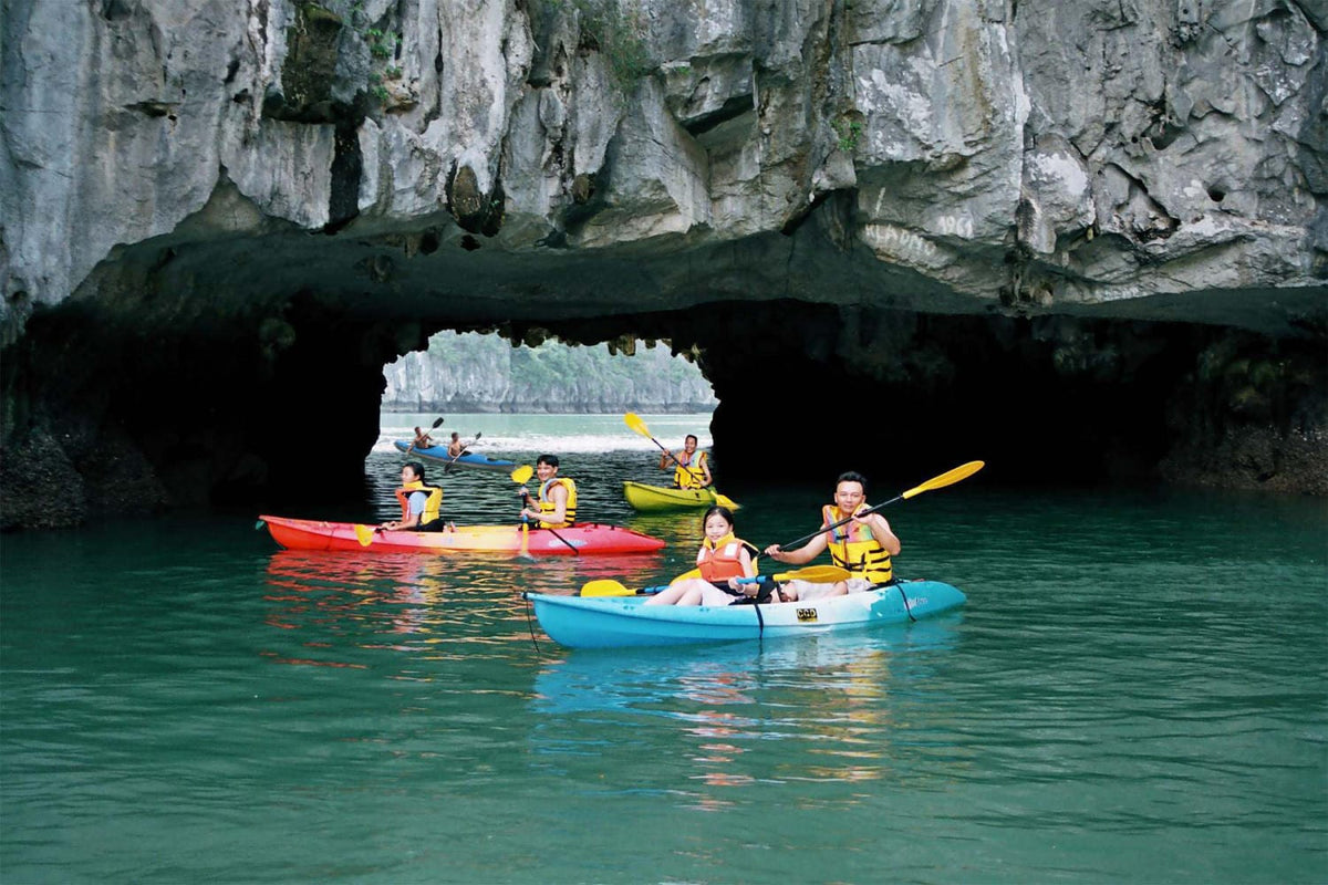 Kayaking through a sea cave on a Ha Long Bay cruise