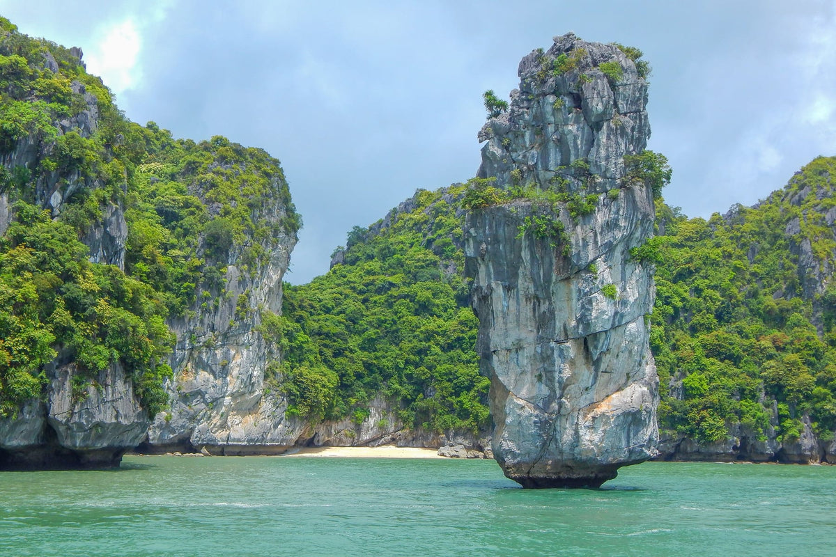 Tall limestone pillar rising from Ha Long Bay