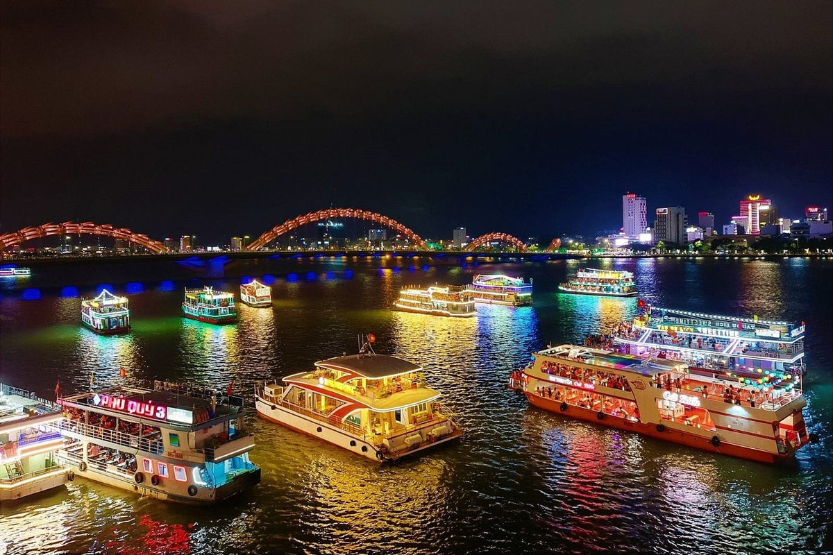 Boats and Dragon Bridge on the Han River at night, Da Nang