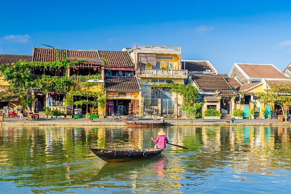 Boat on the Hoai River in front of Hoi An's yellow houses